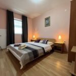 Apartman Jasna spavaća soba s bračnim krevetom, lampama i uređenim interijerom